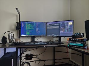 A picture of my desktop setup, with a few of the books I use to study on the desk, beside the screens.
